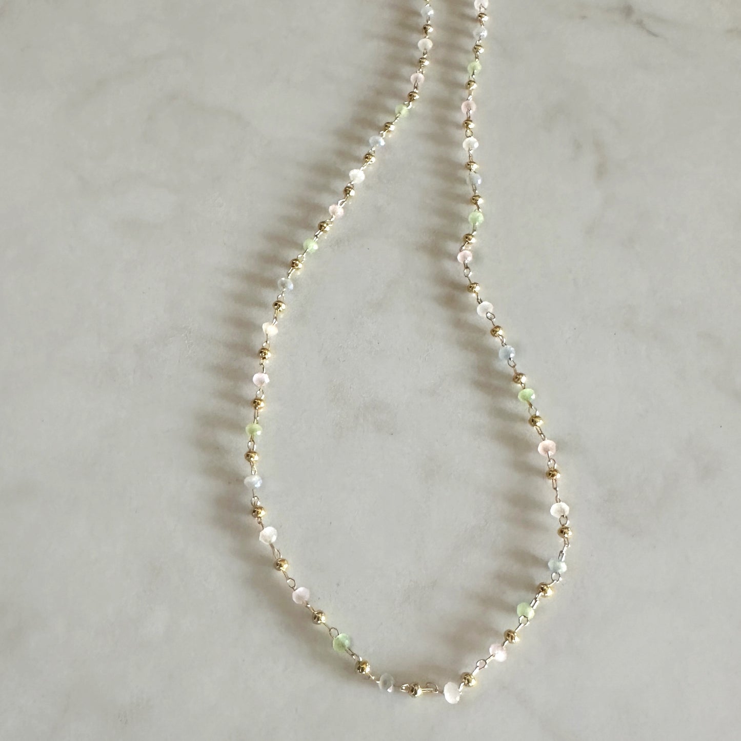 Necklace with small beads on a light gray background