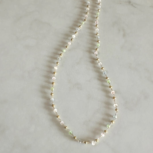 Necklace with small beads on a light gray background
