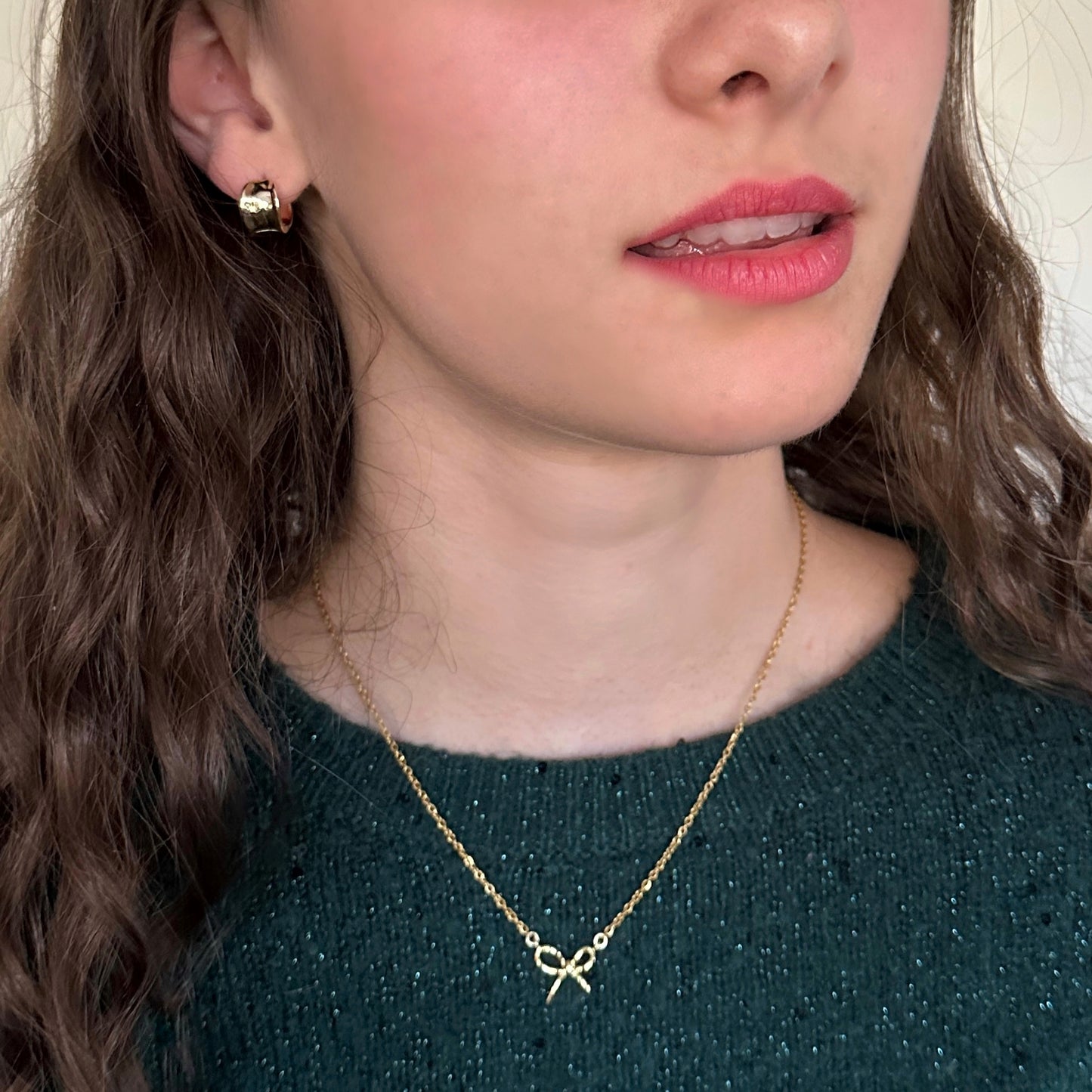Close-up of a person wearing a gold necklace with a star pendant.